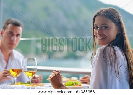 happy young couple having lanch at beautiful restaurant on the beach