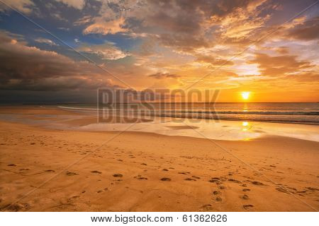 Tropical beach in ebb time on sunset background