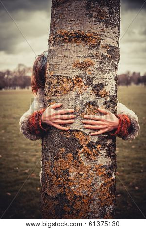 Woman Hugging A Tree