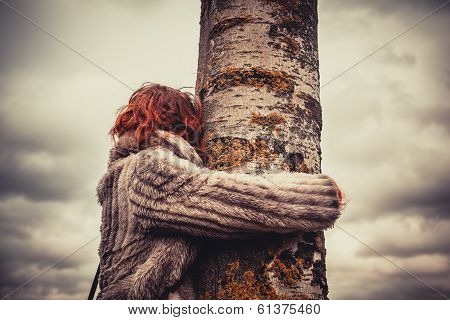 Woman Hugging A Tree