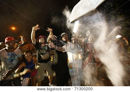 Revelers fling baby powder