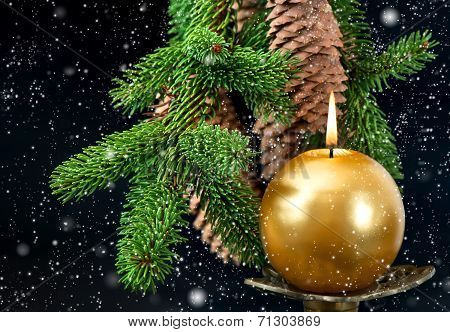 Christmas Tree Branch With Golden Burning Candle
