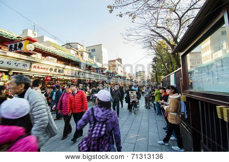 Tokyo, Japan - November 21, 2013: Tourists Visit Nakamise Shopping Street In Asakusa