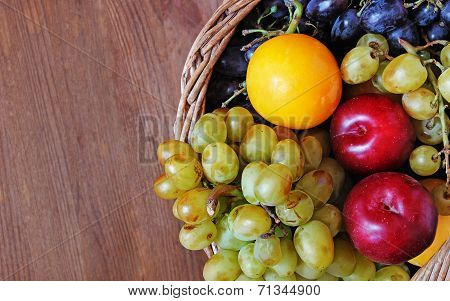 Fresh Fruit In The Basket On The Wooden Table