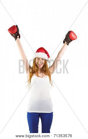 Festive redhead cheeering with boxing gloves on white background
