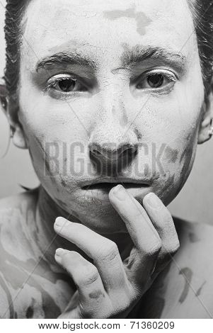 Portrait of girl's mud face. black and white photo