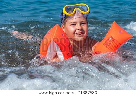 Boy Learning To Swim With Oversleeves