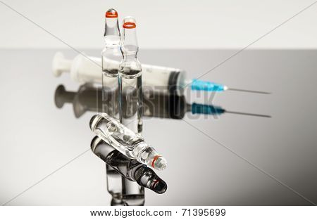 Ampules And Syringe Isolated On Black Background