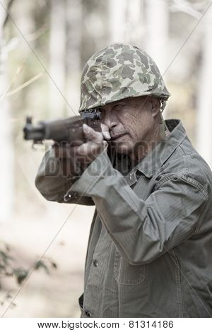 man in period accurate world war two uniform firing weapon