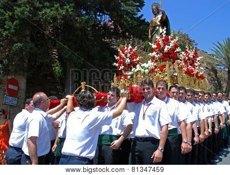 Carrying float through Marbella streets.