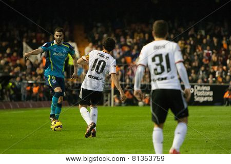VALENCIA, SPAIN - JANUARY 25: Iborra with a ball and Parejo during Spanish League match between Valencia CF and Sevilla FC at Mestalla Stadium on January 25, 2015 in Valencia, Spain