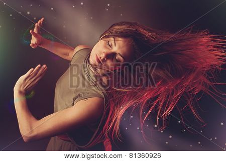 Beautiful Woman Dancer Dancing Over Dark Background With Light Rays And Star Swirls