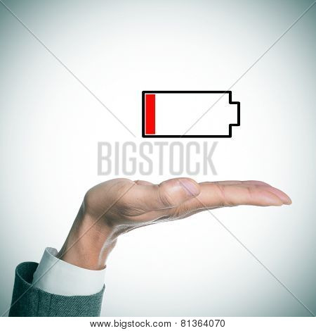 the hand of a businessman holding an illustration of a low battery