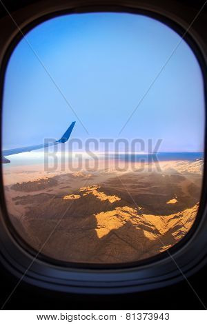 View from an airplane above clouds going home
