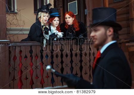 Girls Discuss Man In Retro Suit.