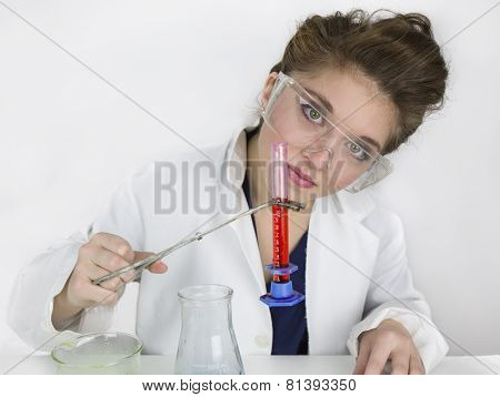 Teenage girl wearing goggles doing science experiment