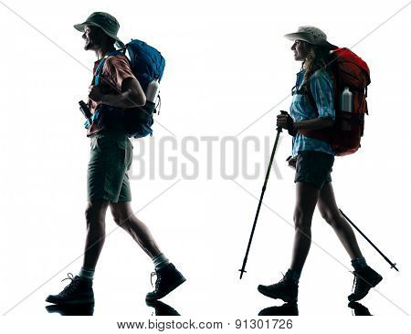 one caucasian couple trekker trekking walking nature in silhouette isolated on white background