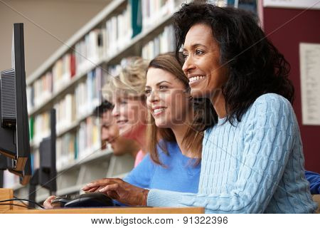 Students working on computers in library