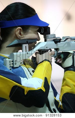 Woman Aiming A Pneumatic Air Rifle