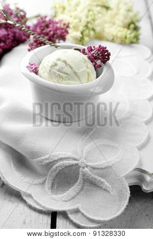 Beautiful composition with tasty ice cream and lilac flowers