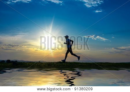 Silhouette Man Running On Meadow Over River, Sunrise -sundown Sky At Background. Runner - Sprinter O