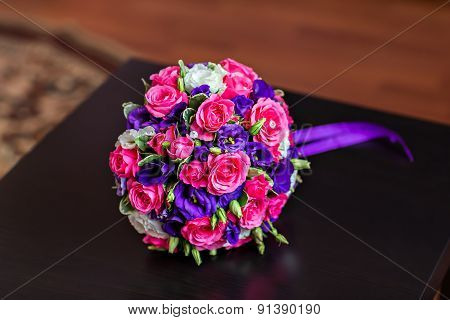 Bride Holding Wedding Bouquet with beautiful Flowers