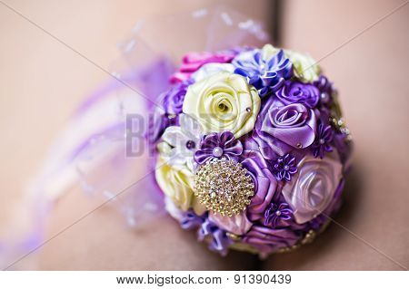 Bride Holding Wedding Bouquet with beautiful Flowers