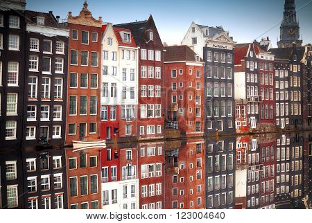 Canal houses of Amsterdam at dusk with vibrant reflections Netherlands