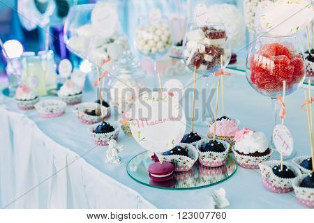 Dessert Sweet Tasty Cupcakes In Candy Bar On Table. Delicious Sweet Buffet. Bright Wedding Decorations
