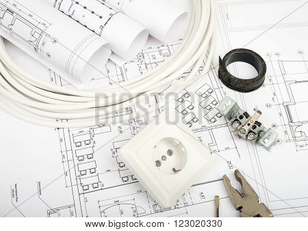 Architecture plan and rolls of blueprints with cabel and plug. Building concept