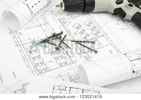 Architecture plan and rolls of blueprints with cabel and electric screwdriver. Building concept