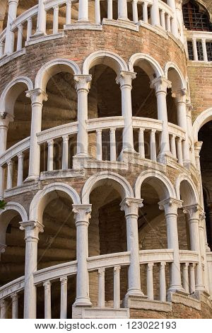 Architecture landmark Palace Contarini del Bovolo with famous staircase and blue cloudy sky in Venice Italy