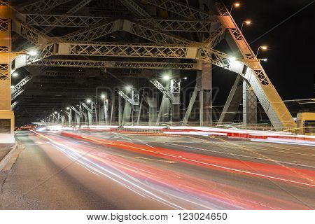 BRISBANE, AUSTRALIA - MARCH 3 2016: Brisbane Story Bridge night traffic. The bridge spans the Brisbane River and carries vehicular, bicycle and pedestrian traffic.