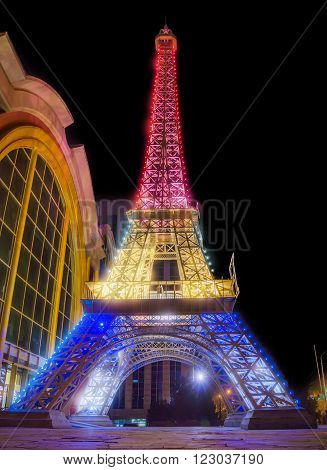 ALMATY KAZAKHSTAN - MARCH 23 2016: Night view of reduced copy of Eiffel Tower on the street Furmanova. Almaty is the largest city in Kazakhstan and was the country's capital until 1997.