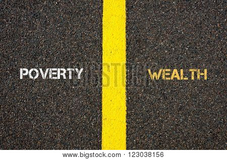 Antonym concept of POWERTY versus WEALTH written over tarmac, road marking yellow paint separating line between words
