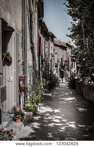 sweet village street in france in summer time