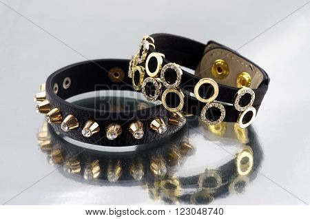 Leather bracelet with pikes on mirrorlike background