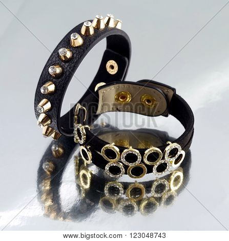 Leather bracelet with pikes on mirrorlike background