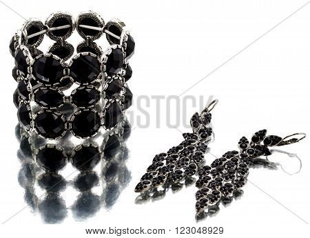 Silver bracelet with black gems on mirrorlike background