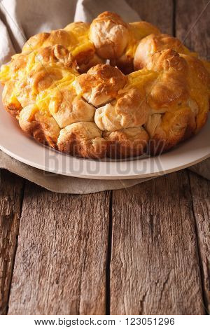 Homemade monkey bread with cheese on a plate. Vertical