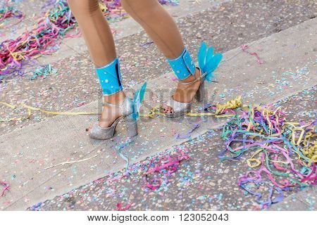 Legs and shoes girls at the carnival. Scattered confetti.
** Note: Shallow depth of field
