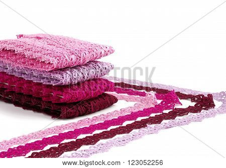 Reddish lace stretched over white background - pink, wine, raspberry-red