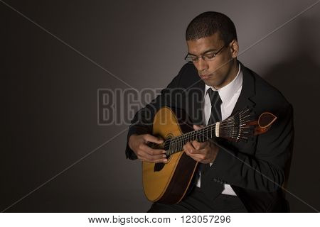 fado musician with a portuguese guitar, studio
