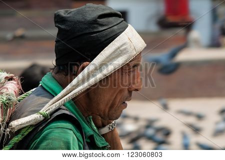 Katmandu, Nepal -  April 15 2013: Nepali Man With A Basket For Carrying Heavy Loads On Their Heads.