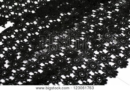 Black floral tracery lace on white background
** Note: Shallow depth of field
