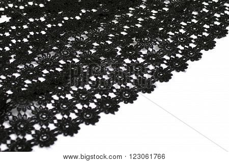 Black floral tracery lace on white background
** Note: Shallow depth of field
