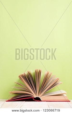 Open book on green wooden bavkground. Education background