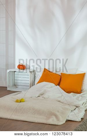 Unmade Bed In Simple Autumn Bedroom