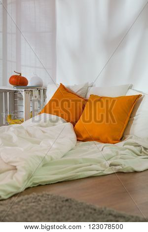 Unmade Bed In Modest Room