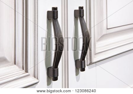 silver handles with snaps on  cabinet doors